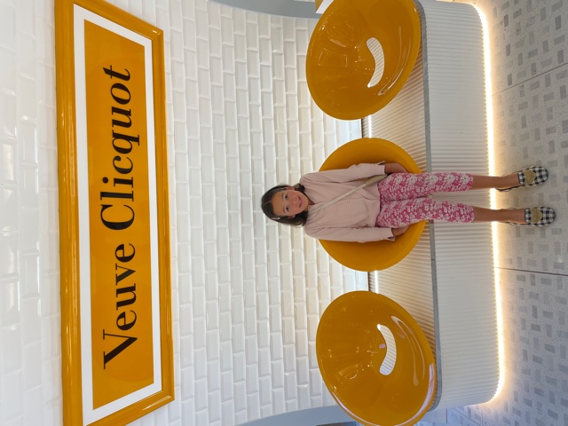 Mia in Veuve Cliquot chair.